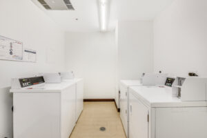 Interior Laundry Facilities, 2 washers 2 dryers, tile floor, white walls.
